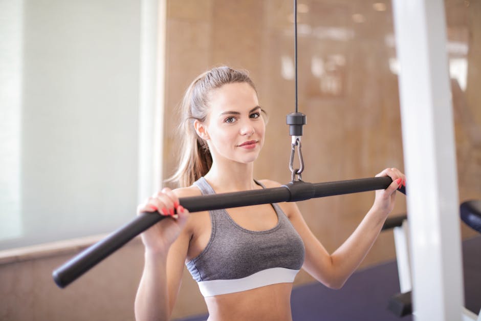 Young woman using gym equipment for strength training in a modern fitness facility
